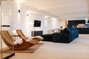 a living room with a chair and a couch at Barrierefreies Loft Apartment in Dessau