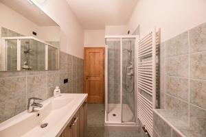 a bathroom with a sink and a shower at La pratolina piano terra in Castello di Fiemme