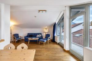 a living room with a couch and a table at Fewo Brünnstein - Zimmer 65 in Oberaudorf
