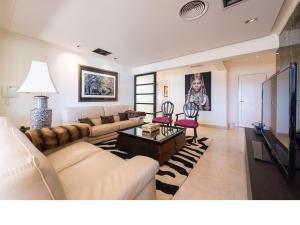 a living room with a couch and a table at Chalet en la playa San Agustin in Maspalomas