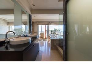 a bathroom with two sinks and a large mirror at Chalet en la playa San Agustin in Maspalomas +32 photos