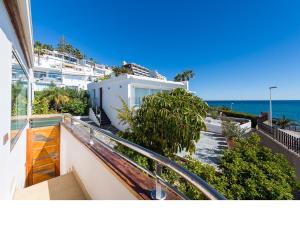 a balcony of a house with a view of the ocean at Chalet en la playa San Agustin in Maspalomas