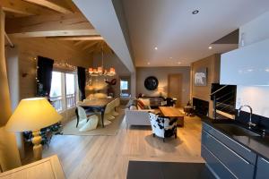 a kitchen and living room with a couch and a table at Les Craterelles 3 - 1650 in Courchevel
