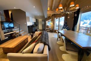 a living room with a table and a dining room at Les Craterelles 3 - 1650 in Courchevel