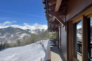 a house with a view of the snow covered mountains at Les Craterelles 3 - 1650 in Courchevel