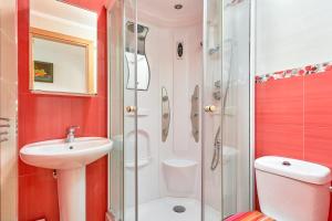 a bathroom with a shower and a sink and a toilet at Naranja apartment in Nerja +16 photos