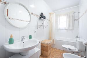 a white bathroom with a sink and a mirror at Casa del Practicant in Culla +21 photos