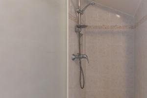 a shower with a shower head in a bathroom at Chez l'Oncle in Gras +14 photos