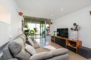 a living room with a couch and a tv at Ca Na Xisca in Sa Pobla