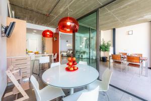 a kitchen and dining room with a white table and chairs at Ca Na Xisca in Sa Pobla