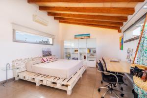 a bedroom with a bed on a wooden platform and a desk at Ca Na Xisca in Sa Pobla