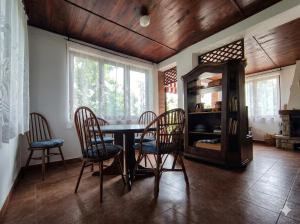 a dining room with a table and chairs at Мечта in Kruče