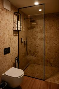 a bathroom with a toilet and a shower at Maravida Vacation Rooms in Dobrovo