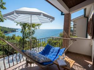 a porch with a hammock and a view of the ocean at Мечта in Kruče +6 photos