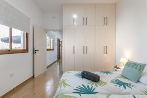 a bedroom with a bed and white cabinets at Vista Valle in La Orotava
