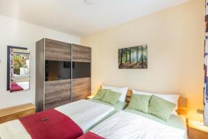 a bedroom with a bed with a red blanket at Ferienwohnung Holterhoff in Olpe