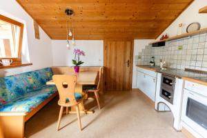 a kitchen with a couch and a table in a room at Haus Simon in Nova Levante