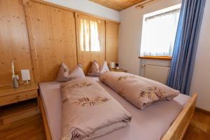 a bedroom with two beds and a window at Haus Simon in Nova Levante