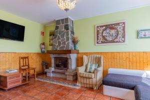 a bedroom with a fireplace and a bed and a chair at Angela in Isla