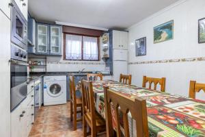 a kitchen with a table and chairs and a washing machine at Angela in Isla