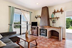 a living room with a fireplace and a couch at Villa Perez Zara Paco in Campano