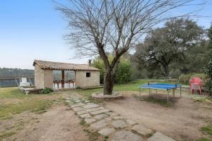 a house with a ping pong table in a yard at Casa Subiraneta in Puigreig