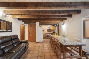 a living room with a table and a couch at Casa Subiraneta in Puigreig