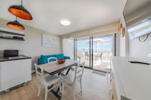 a kitchen and dining room with a table and chairs at Résidence Le Rêve Apt 209 in La Tranche-sur-Mer
