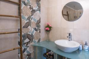a bathroom with a sink and a mirror at Gorgona 1 in Loutra