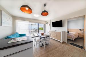 a room with a dining table and a bedroom at Résidence Le Rêve Apt 209 in La Tranche-sur-Mer