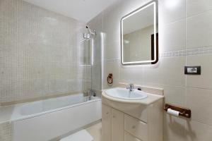 a bathroom with a sink and a tub and a mirror at Apartamento Opuntia in La Orotava +17 photos