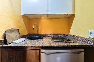 a kitchen counter top with a sink and a sink at Navila Estudio en la piscina in Ibiza Town