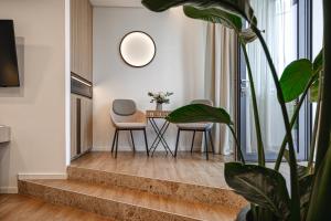 a living room with a table and chairs and a plant at Maravida Vacation Rooms in Dobrovo +14 photos