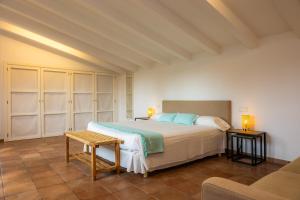 a bedroom with a large bed and a couch at Els Clepes in Son Servera +29 photos