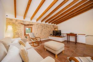 a living room with a white couch and a tv at Els Clepes in Son Servera
