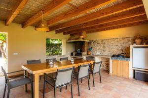 a kitchen with a large wooden table and chairs at Els Clepes in Son Servera