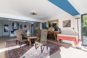 a living room with a table and chairs at El Chiripero Beach Villa in A Coruña