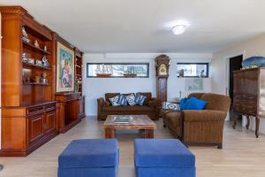 a living room with two couches and a table at El Chiripero Beach Villa in A Coruña