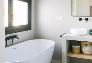 a white bathroom with a tub and a sink at Villa Torre in Jávea +46 photos