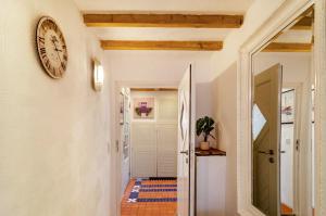 a hallway with a clock on the wall at Huus ant Kornfeld Erdgeschoss in Osteel