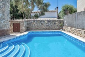 a swimming pool in a house with a stone wall at Casas al Alba in Zahora