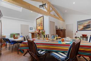a dining room with a long table and chairs at Chambres D'hôtes Sous Le Pin in Les Sables-d'Olonne