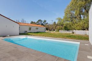 a swimming pool in front of a house at Chambres D'hôtes Sous Le Pin in Les Sables-d'Olonne