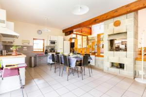 a kitchen and dining room with a table and chairs at le gite à Géo in Thoiry +31 photos