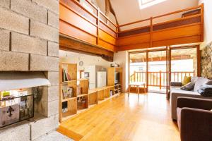 a living room with a couch and a fireplace at le gite à Géo in Thoiry