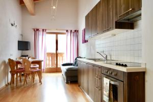 a kitchen and living room with a couch and a table at Huberhof Mareit in Mareta