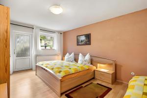 a bedroom with a bed and a window at Ferienwohnung Heidi in Bielatal