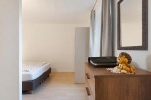 a bedroom with a bed and a wooden table with a toy at Auelehof Laives in Laives