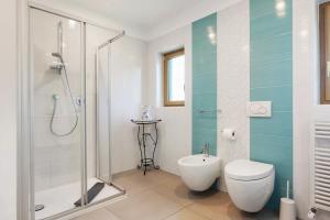 a bathroom with a shower and a toilet and a sink at Auelehof Laives in Laives +46 photos