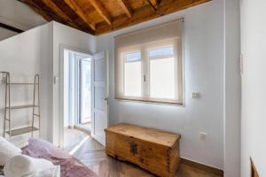 a bedroom with a bed and a wooden trunk in it at Cueva Secreta Güejar in Güéjar-Sierra +37 photos